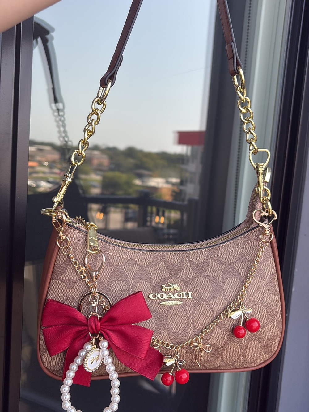 Coach Brown Signature Canvas Shoulder Bag with Red Charm Accents